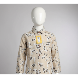 Close-up of beige leaf print cotton shirt on a mannequin, with a yellow product tag.