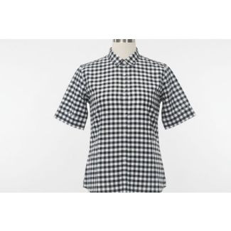Close-up of a black and white gingham checkered shirt with a collar and short sleeves, displayed on a mannequin