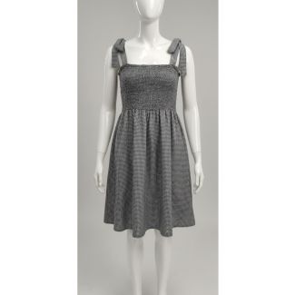 Grey and white gingham pattern sundress on mannequin with smocked bust and bow shoulder ties