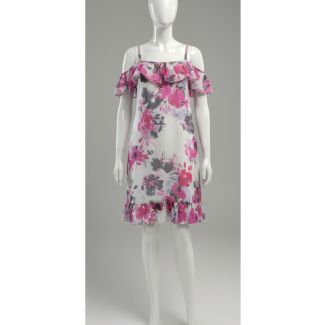 White dress with pink and grey floral print, cold shoulder, and ruffled details