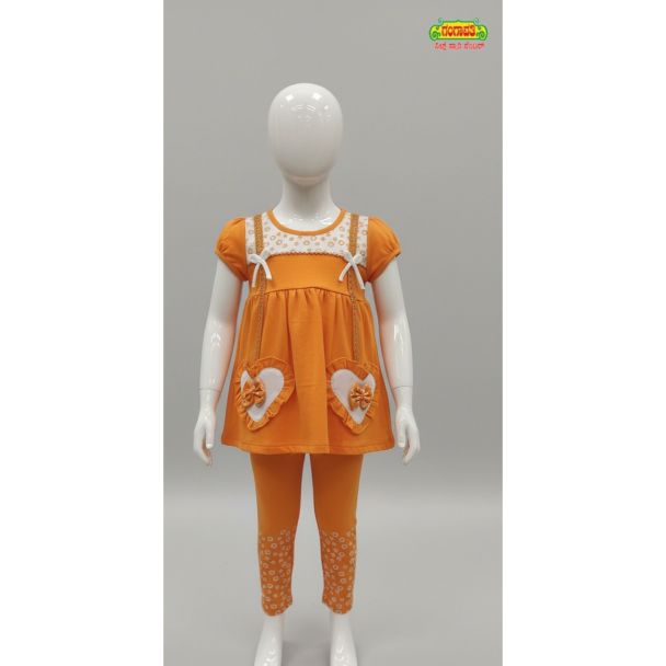 Bright orange kids tunic and printed leggings set displayed on a mannequin in India