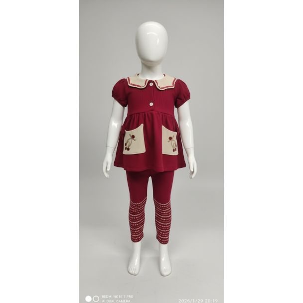 Toddler's deep maroon tunic and patterned leggings set on a mannequin, India