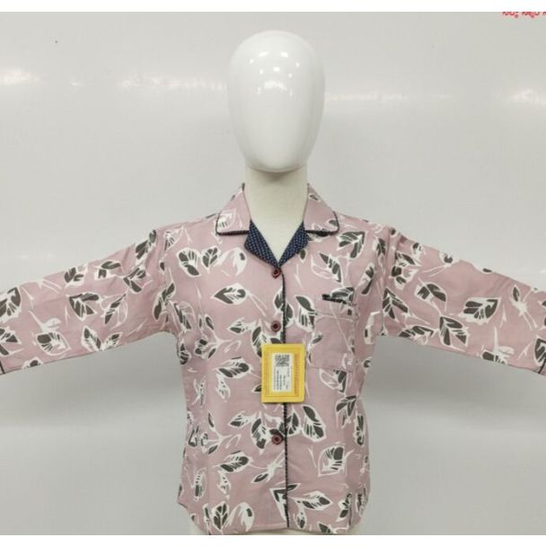 Pale pink pajama set with leaf print, collared shirt, long sleeves, and navy blue accents.
