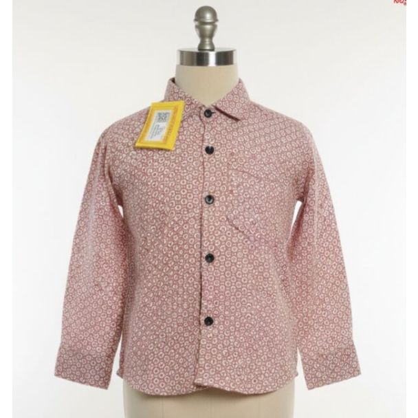 Close up of a brick red cotton shirt with geometric pattern on a mannequin