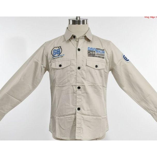 Beige cotton shirt with black buttons, chest pockets, and patches on a mannequin.