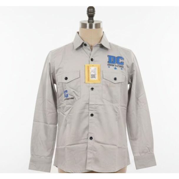 Light grey button-down shirt with long sleeves, black buttons, two pockets, and embroidered graphics.