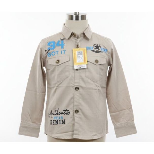Beige cotton shirt with graphic patches, button closure, and long sleeves.