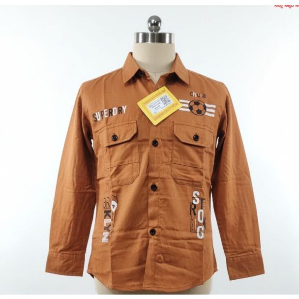 Burnt orange boys' shirt with full sleeves, pockets, and graphic text details displayed on a mannequin