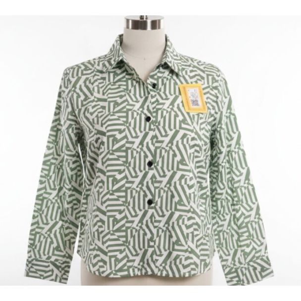 Sage green and white geometric abstract print button-down shirt on a mannequin.