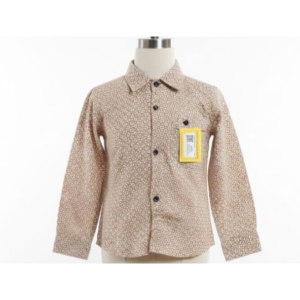 Tan printed button-down shirt with long sleeves on a mannequin torso