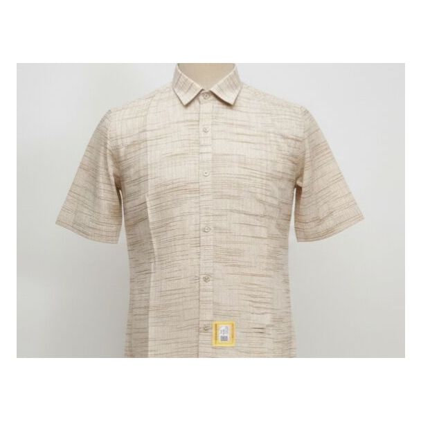 Close-up of a beige textured cotton shirt with short sleeves and a collared neckline on a mannequin