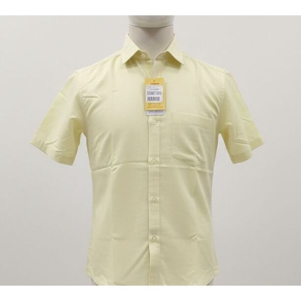 Pale yellow short sleeve dress shirt with button-down closure