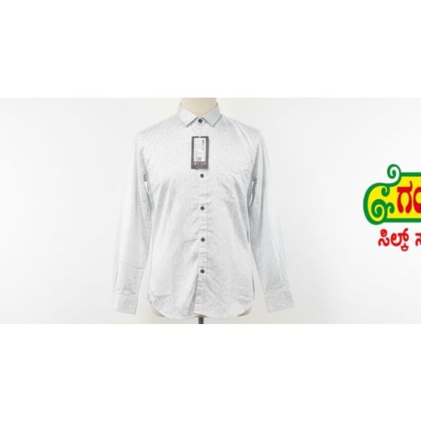 White button-down shirt with a subtle dot pattern, long sleeves, and a classic collar